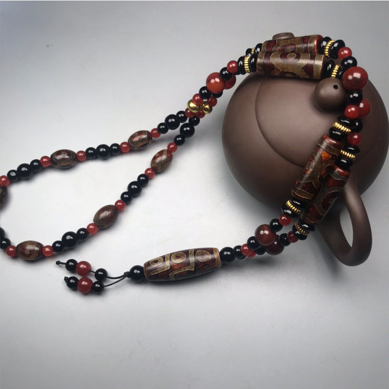 Collier de richesse en agate rouge à neuf yeux (9 x 12 mm)