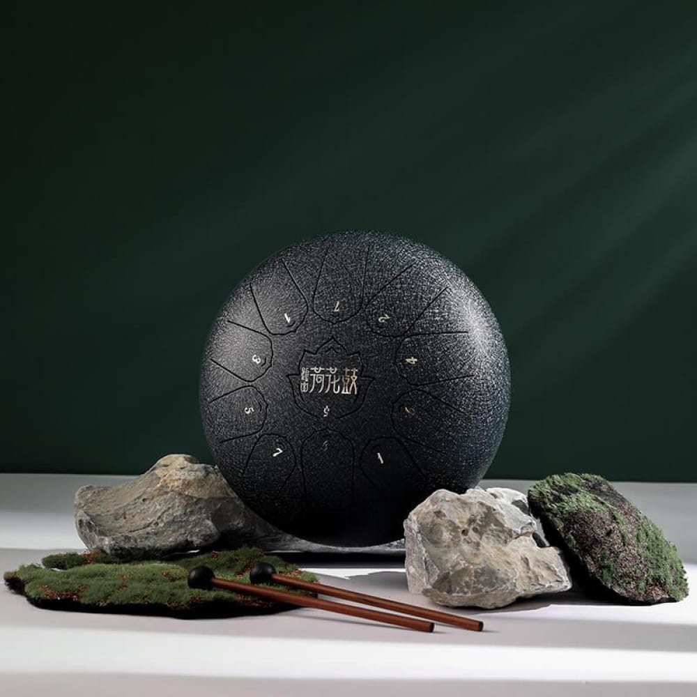 Black steel tongue drum with 11 tone zones in a circular pattern, 10-Inch C Major