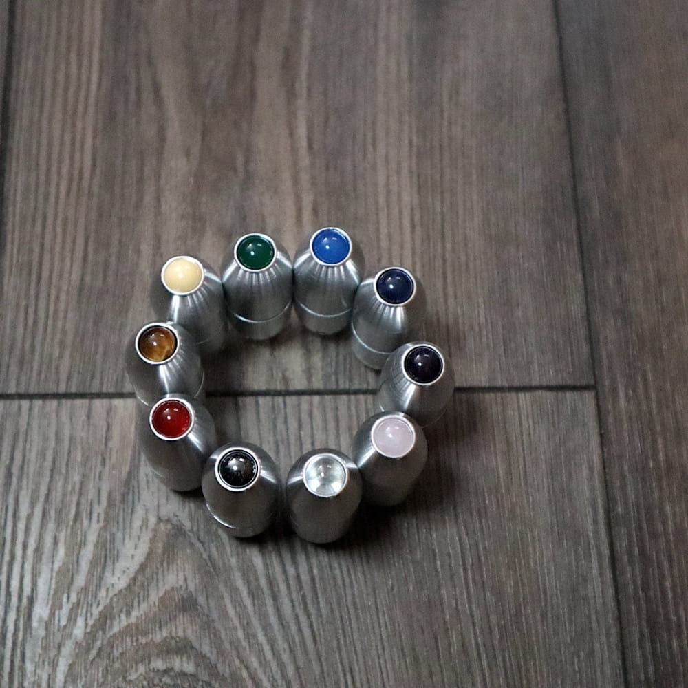 Silver bullet casings in a circle with colorful gemstones for Crystal Tuning Forks