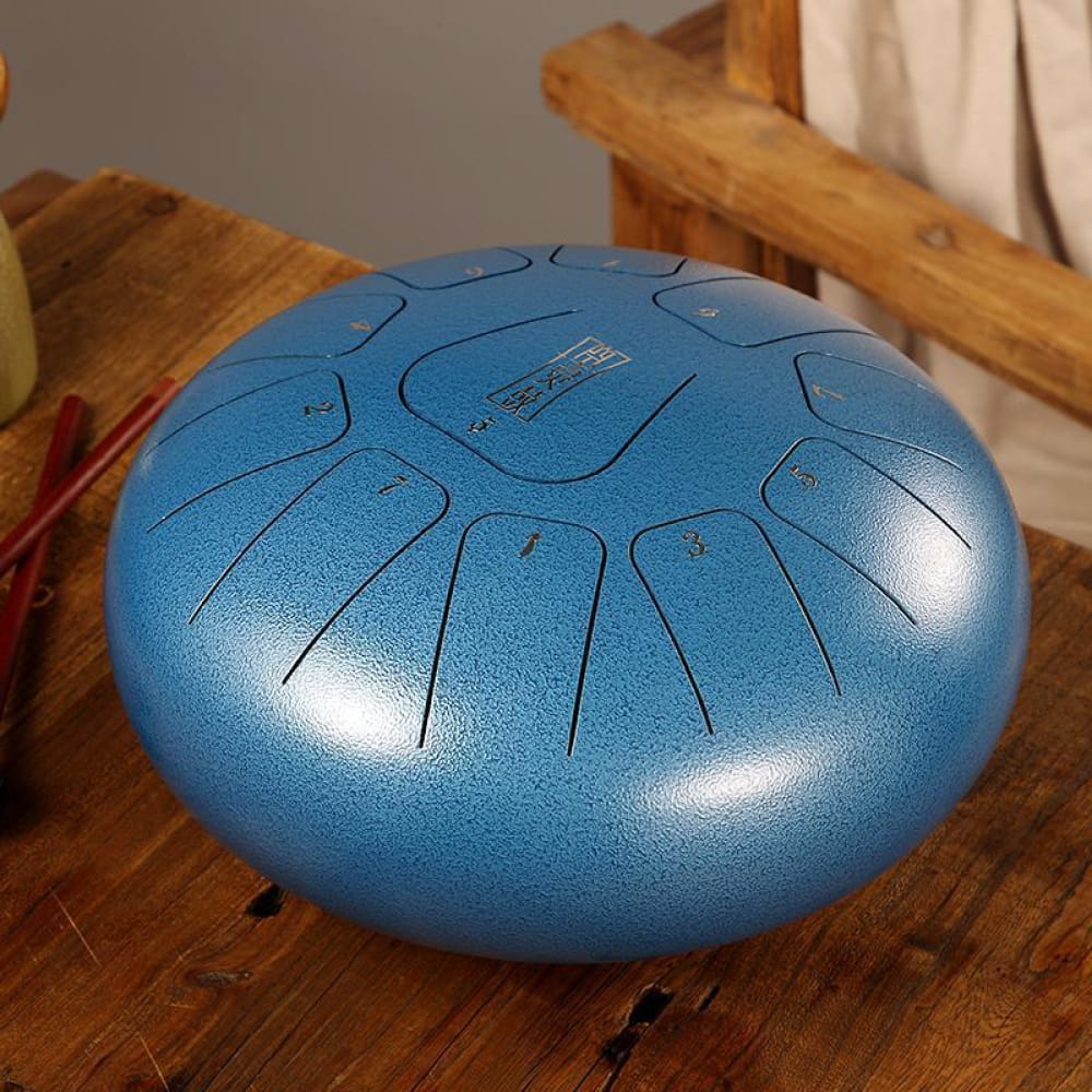 Metallic blue tongue drum with 11 notes, crafted from carbon steel in C key