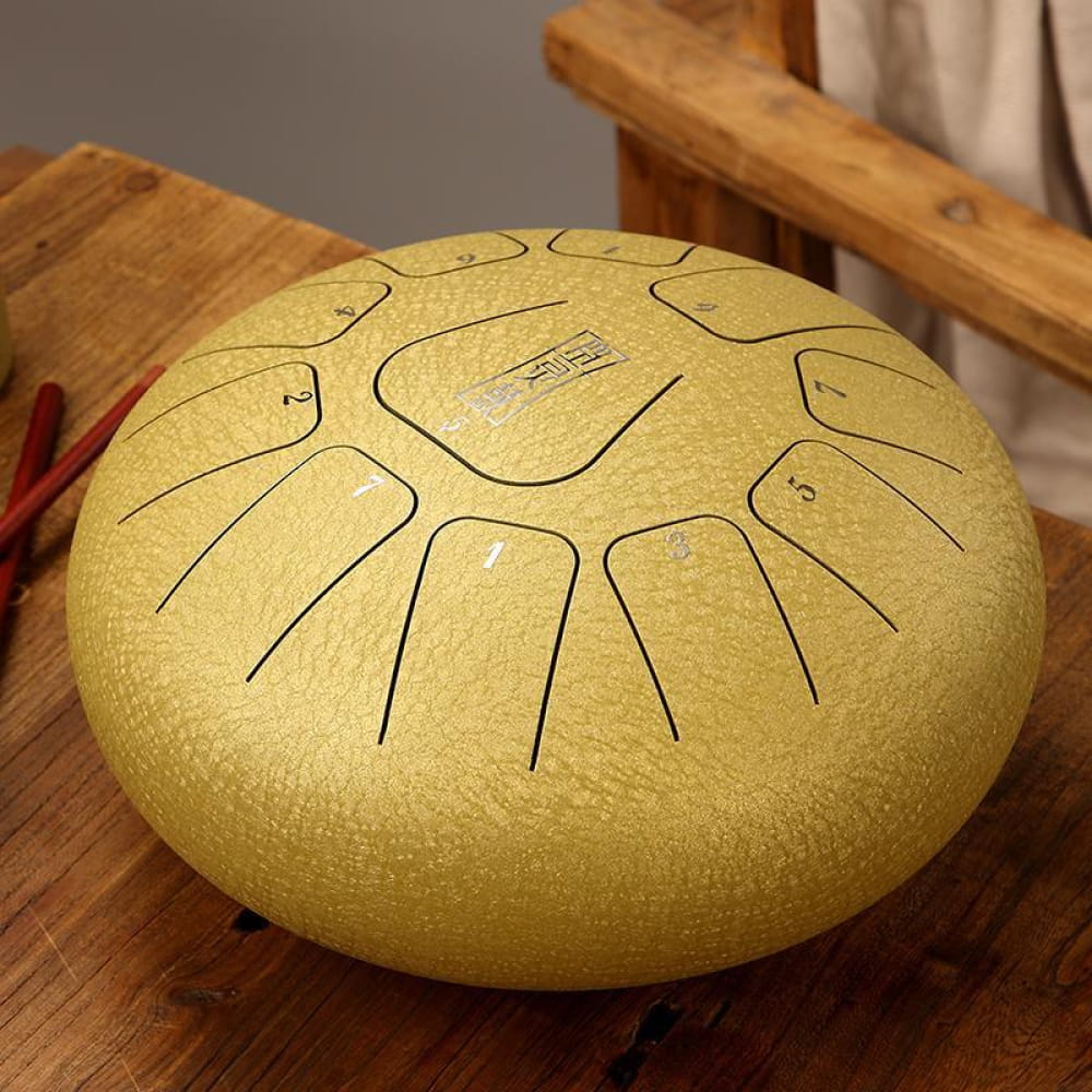 Golden steel tongue drum with curved tone markings in 12-Inch Carbon Steel, 11 Notes in C Key