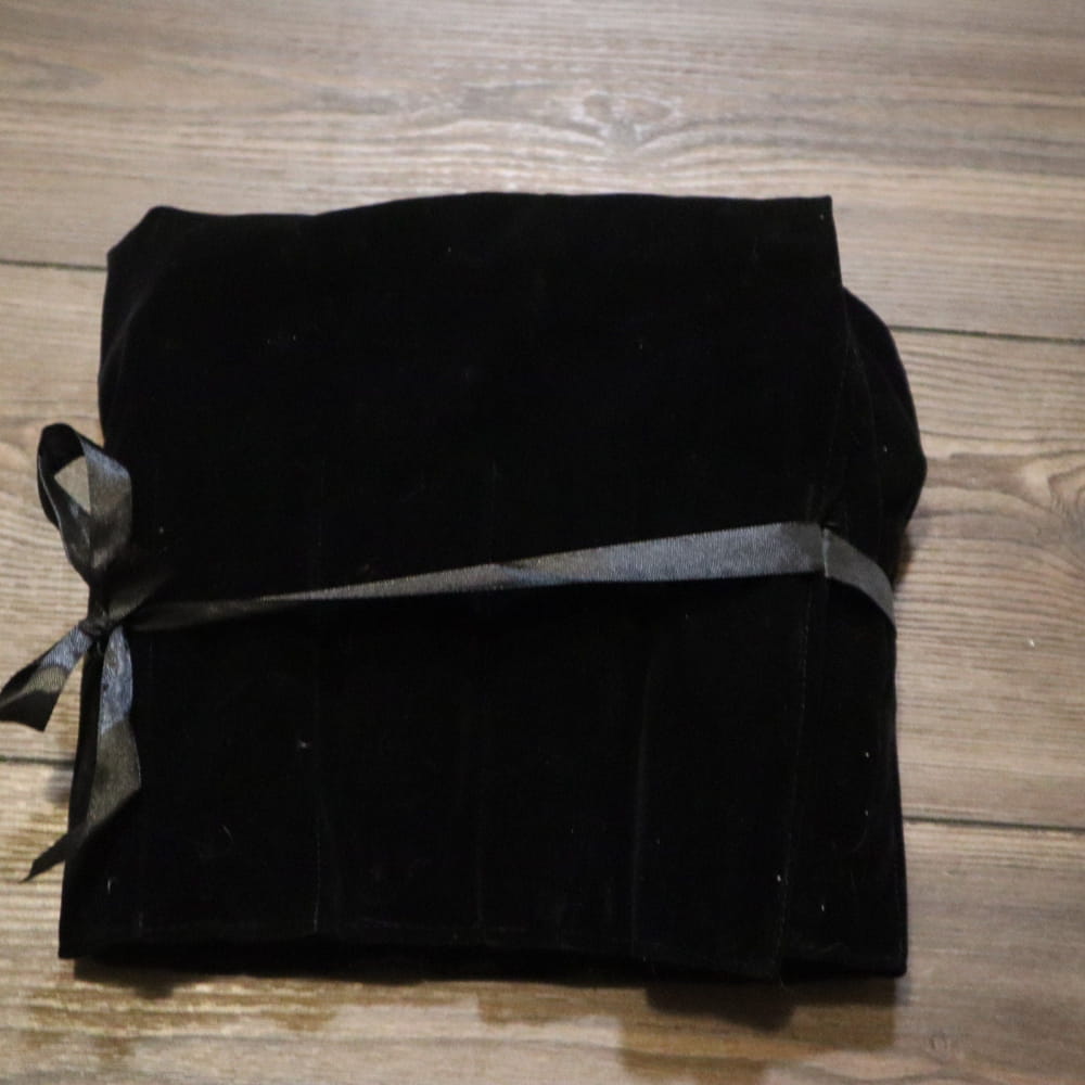 Black fabric roll tied with gray ribbon for 12pc Song of the Spine Tuning Fork Set