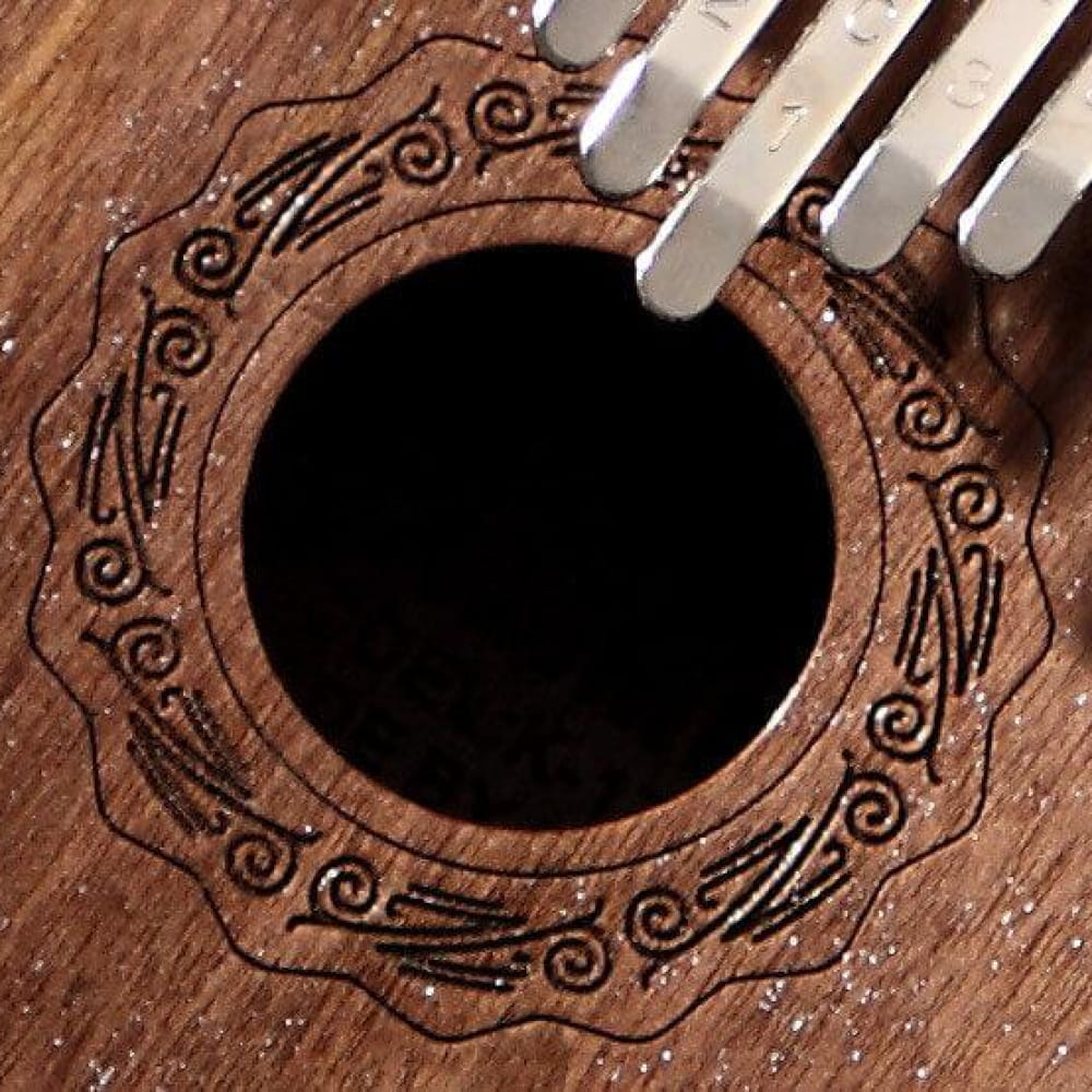 Decorative sound hole of 17 Key Walnut Round Hole Kalimba with spiral carvings