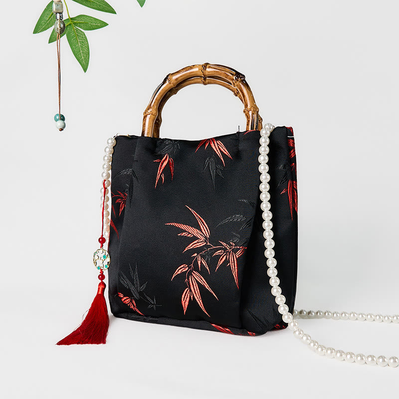 Sac en polyester et coton noir brodé de feuilles avec poignée en bambou