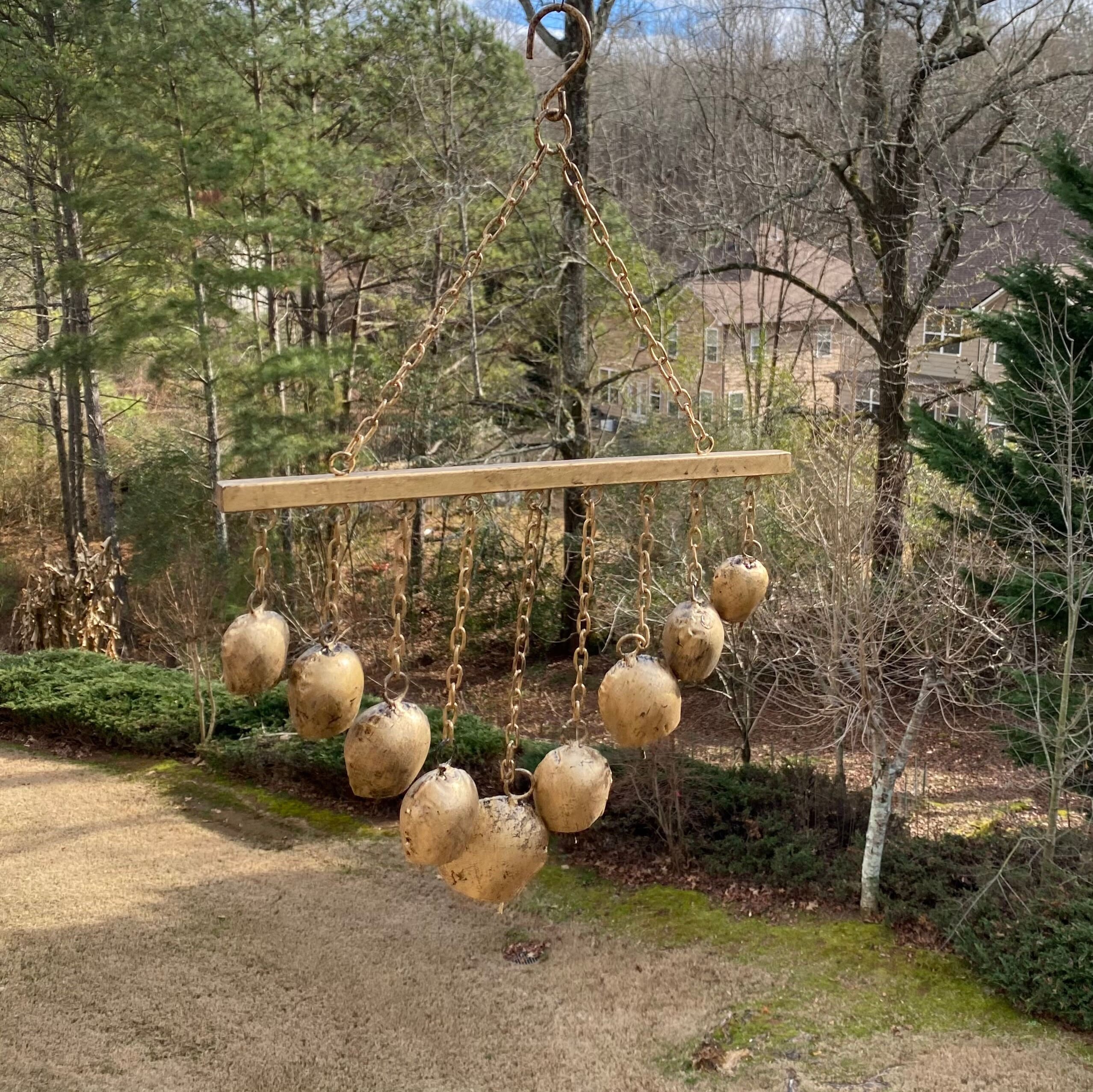 Wooden beam with gold ornamental spheres and chains in Antique Gold Wind Chimes