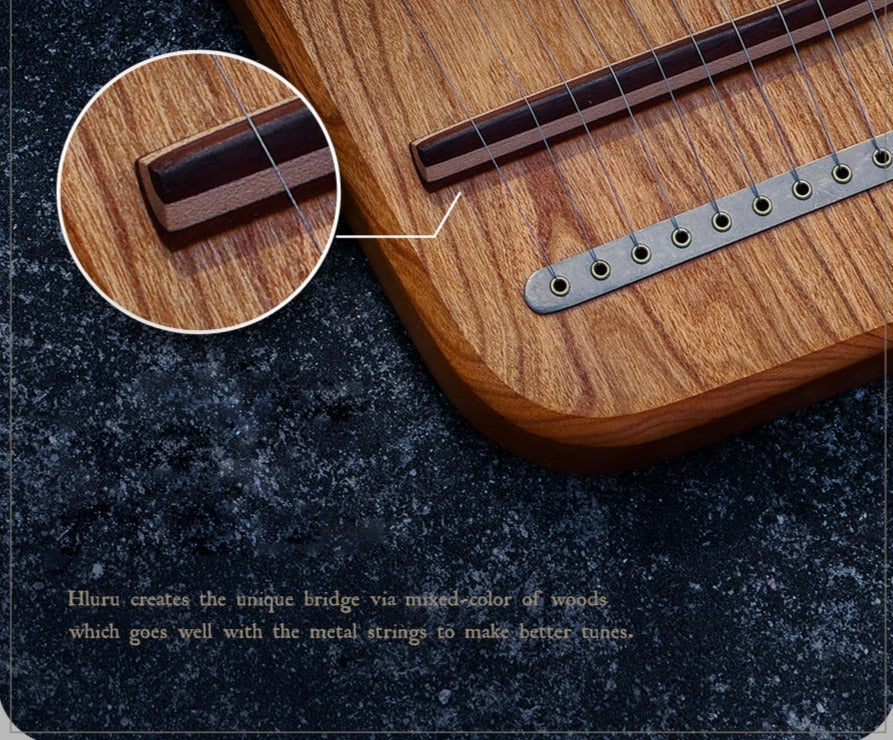Wooden guitar bridge with metal string pins on 19-String Hluru Lyre Harp