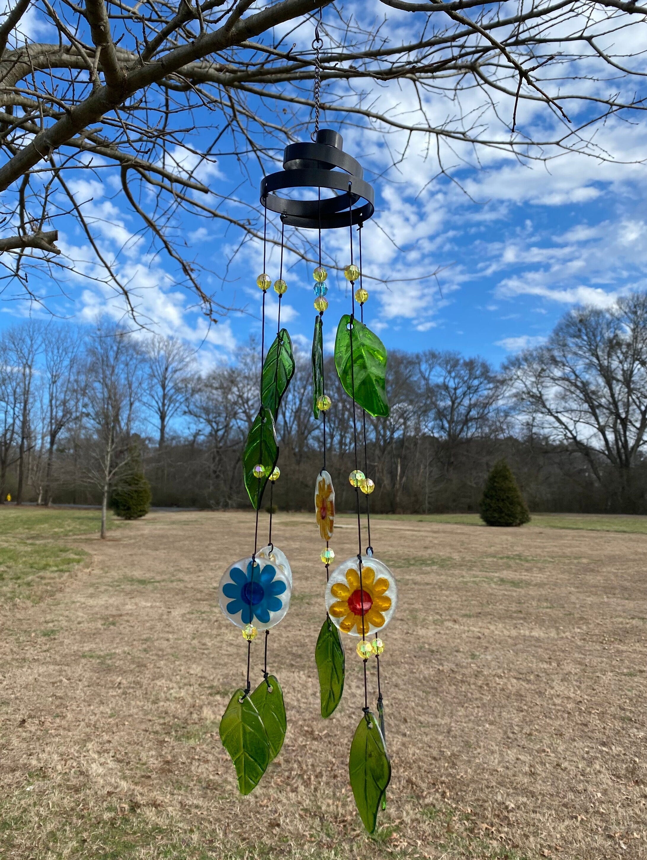 Colorful glass flower wind chime with green leaves for garden peace decor