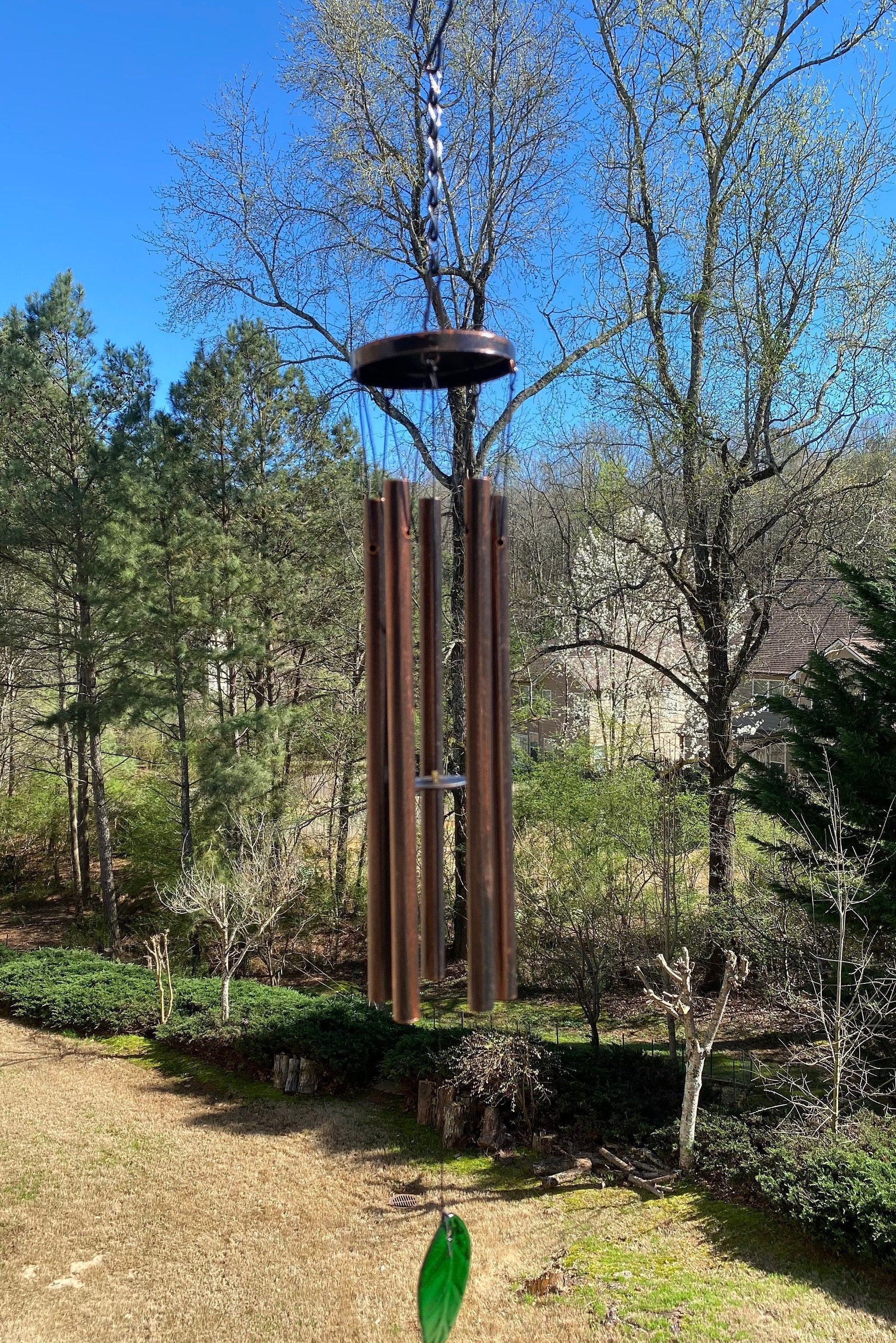 Metal wind chimes with tubular bells and green glass sail in bronze finish