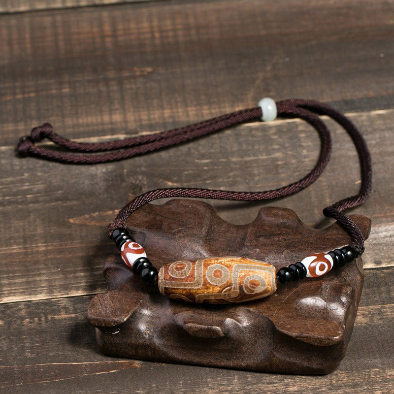 Collier unisexe en perles dzi à neuf yeux | Protection en agate