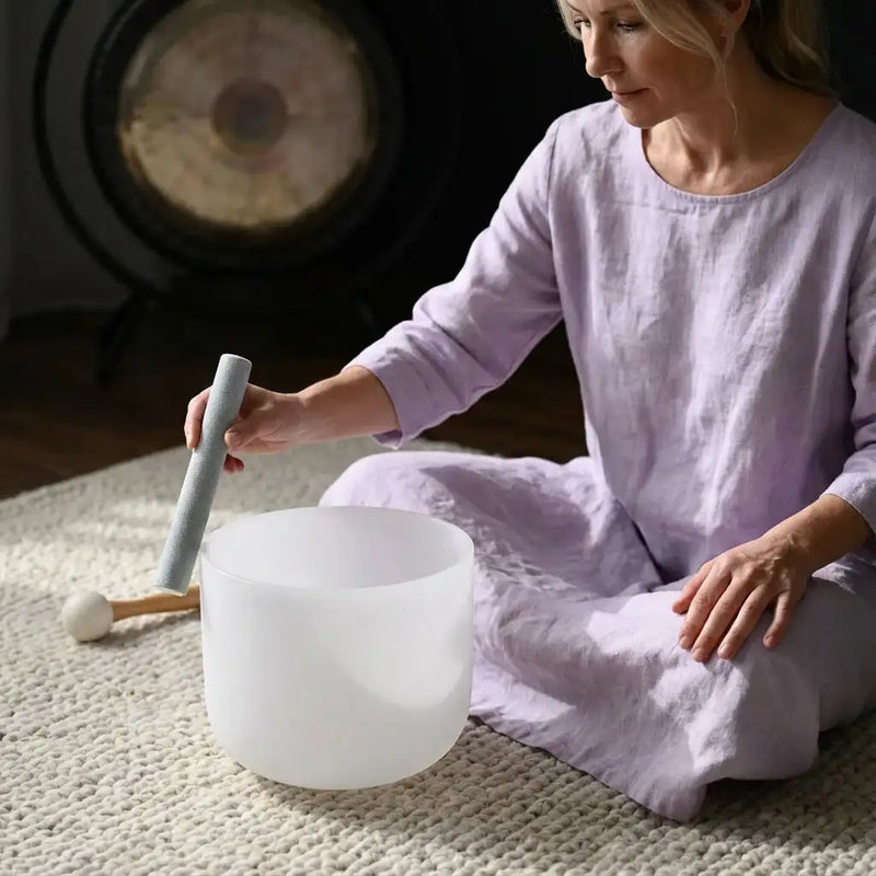 A translucent white crystal singing bowl with a smooth, rounded rim and subtle internal ridges.