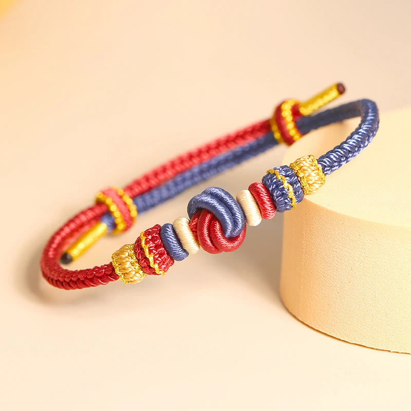 Bracelet en fil rouge bicolore avec nœud de paix fabriqué à la main