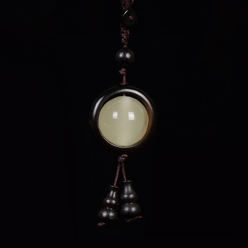 Porte-clés en bois d'ébène « Paix » | Perles lumineuses en bois de santal rouge et vert