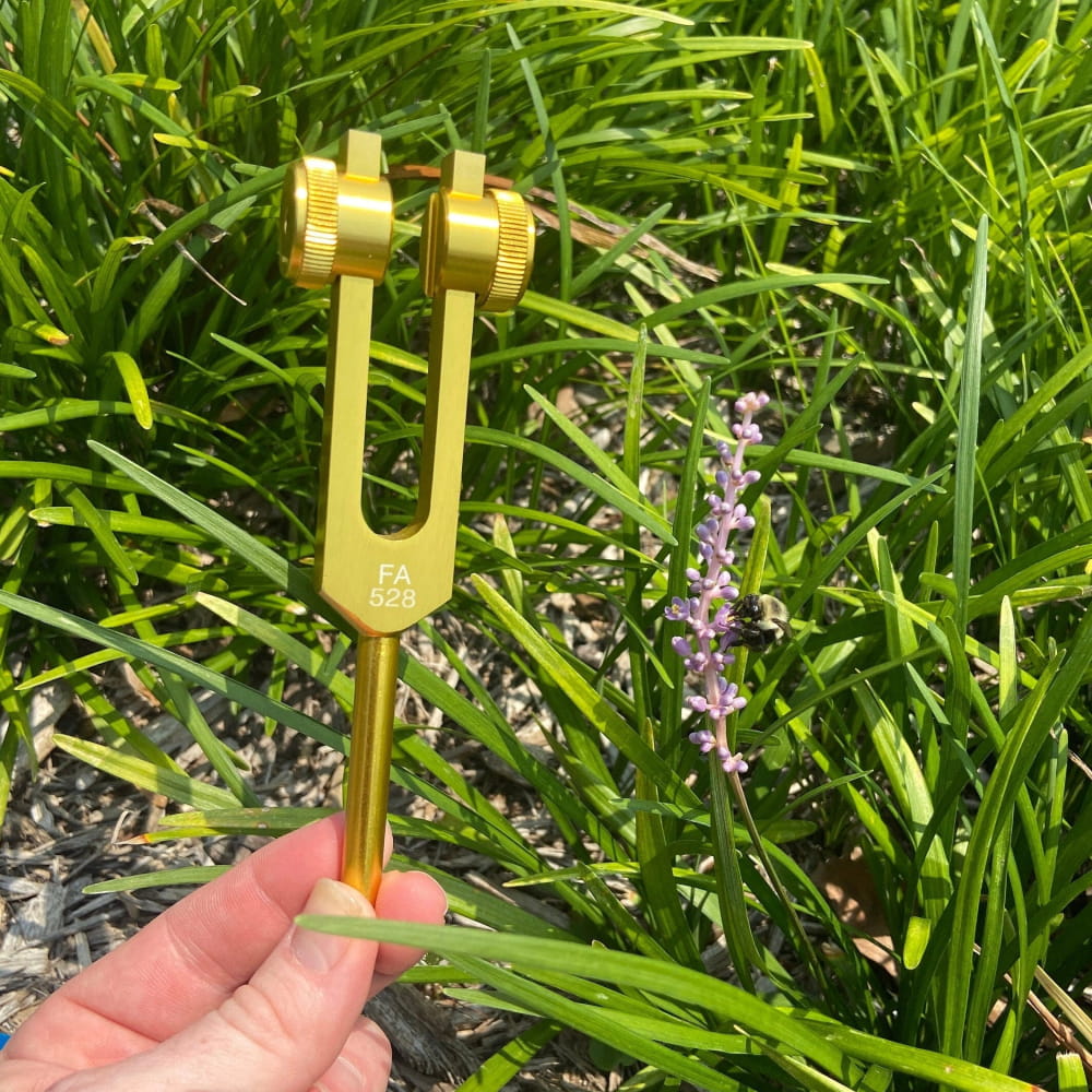 Gold-colored adjustable prong tuning fork for 528 Hz vibrational healing