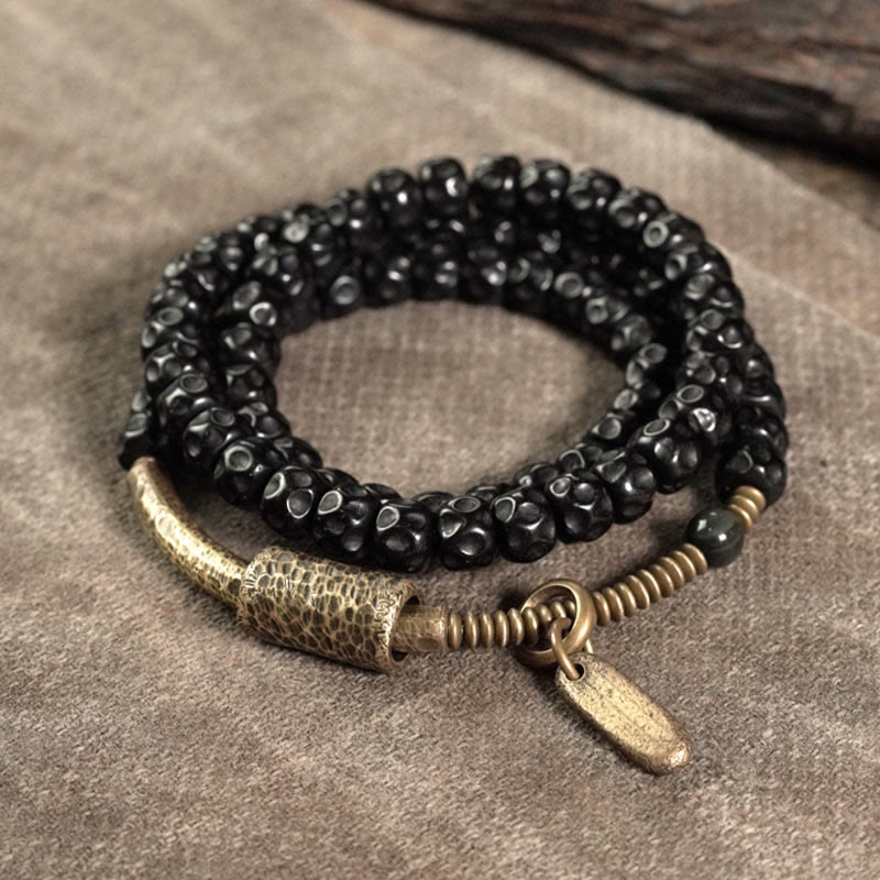 Bracelet spirituel triple tour en cuivre et coquille de noix de coco