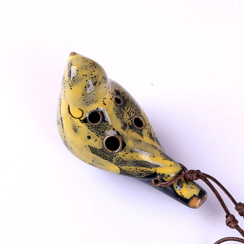 Yellow Ocarina with black spots and holes on a brown cord, ideal beginner’s gift