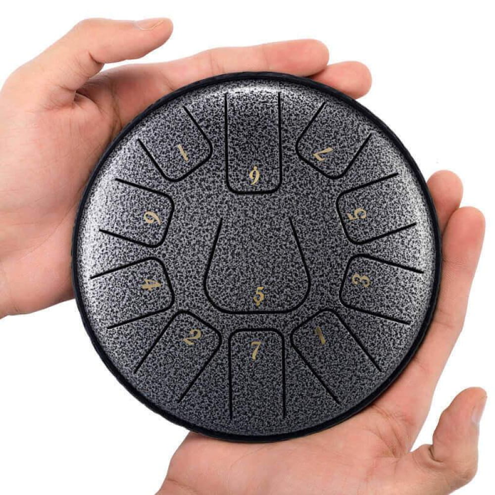 Black steel tongue drum with numbered segments in circular pattern, 6-Inch, D Key