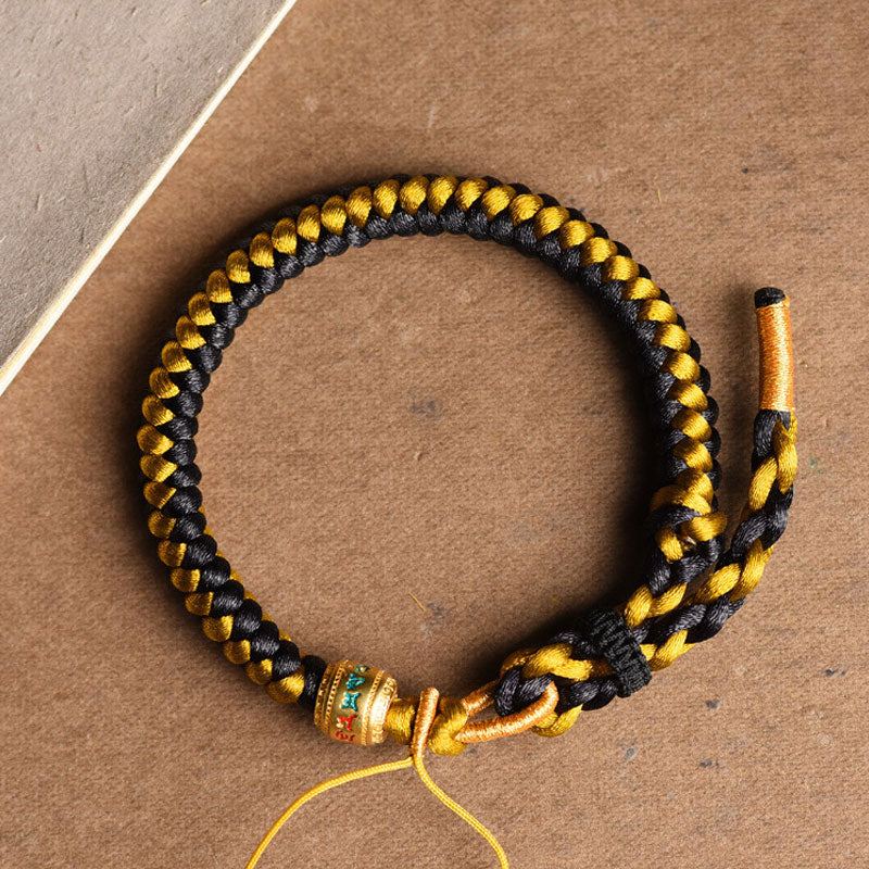 Bracelet en corde noire et or tibétain Om Mani Padme Hum