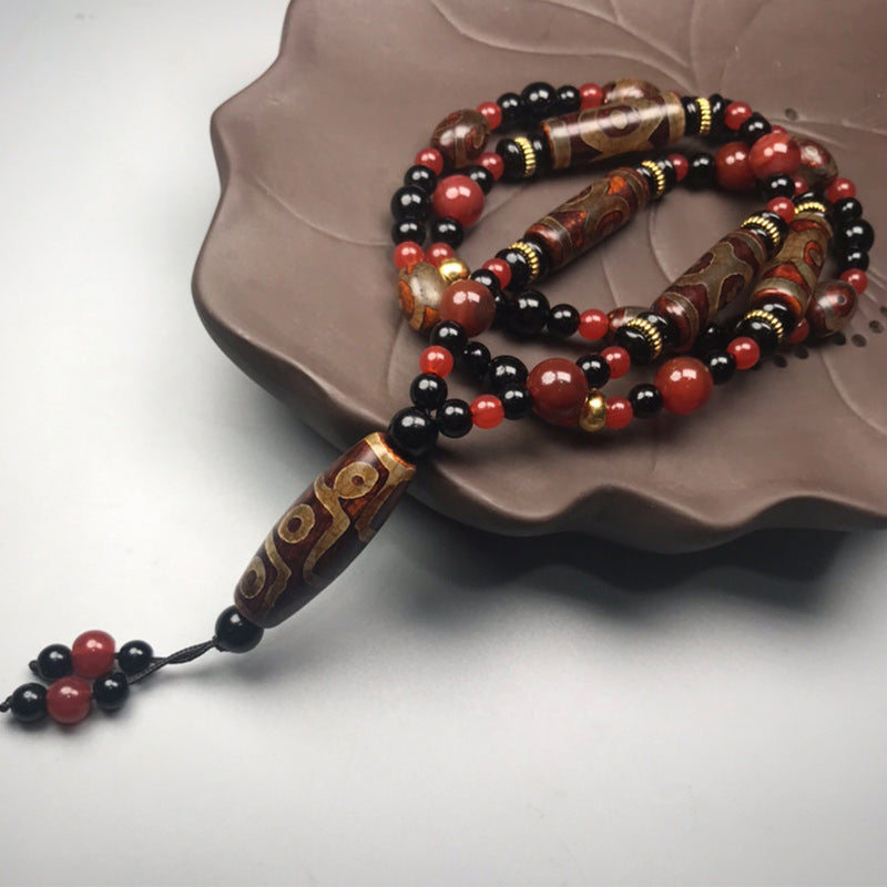 Collier de richesse en agate rouge à neuf yeux (9 x 12 mm)
