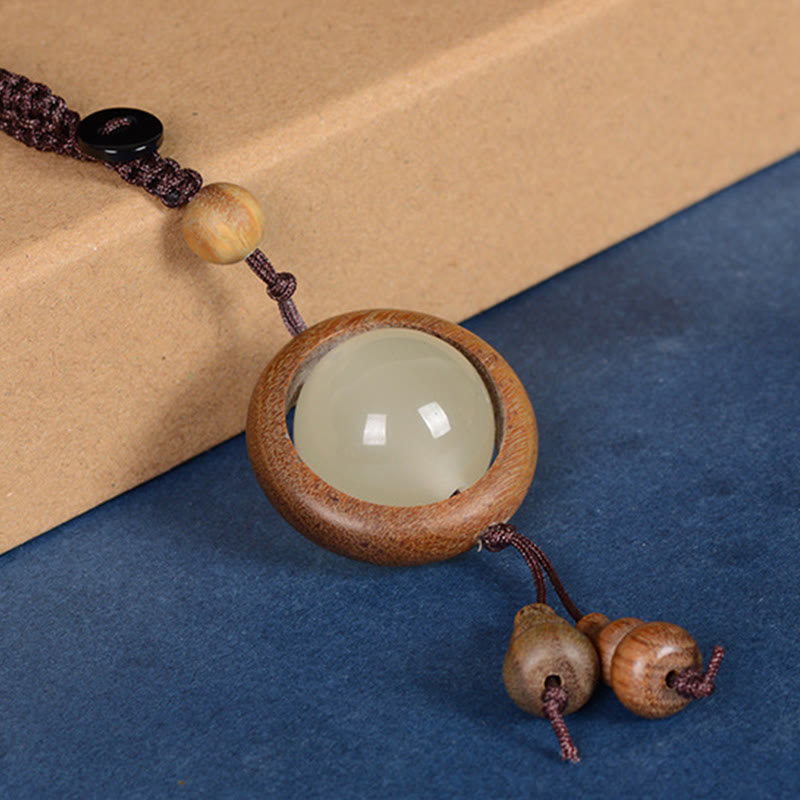 Porte-clés en bois d'ébène « Paix » | Perles lumineuses en bois de santal rouge et vert