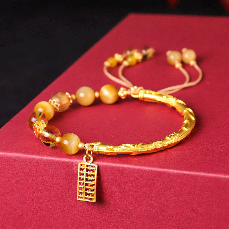 Bracelet de protection en citrine œil de tigre 8 mm avec breloque boulier