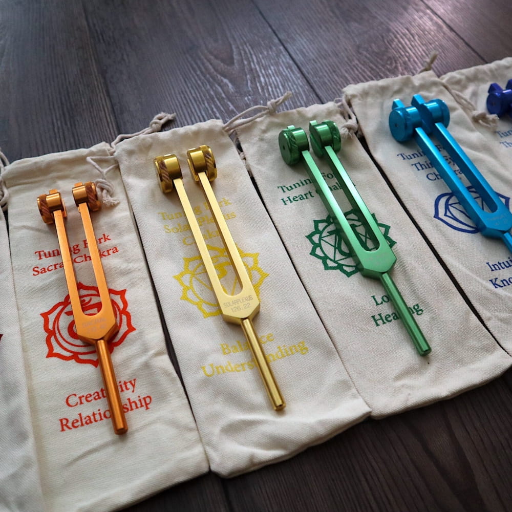 Colorful chakra tuning forks on fabric pouches for biofield and soul healing