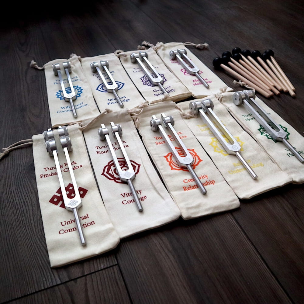 Collection of drumsticks in labeled canvas sleeves for enhancing chakra healing