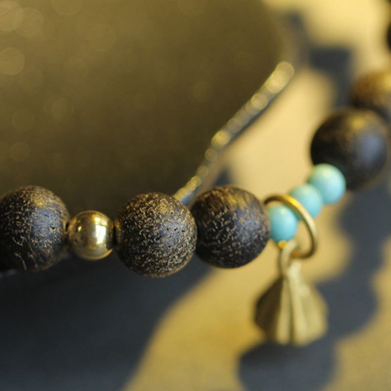 Bracelet de force en bois d'agar et lotus pour l'équilibre et le calme