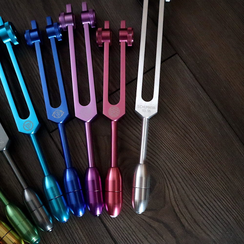 Colorful tuning forks in a row from 9pc Chakra Tuning Forks Set with Crystal Massage Kit