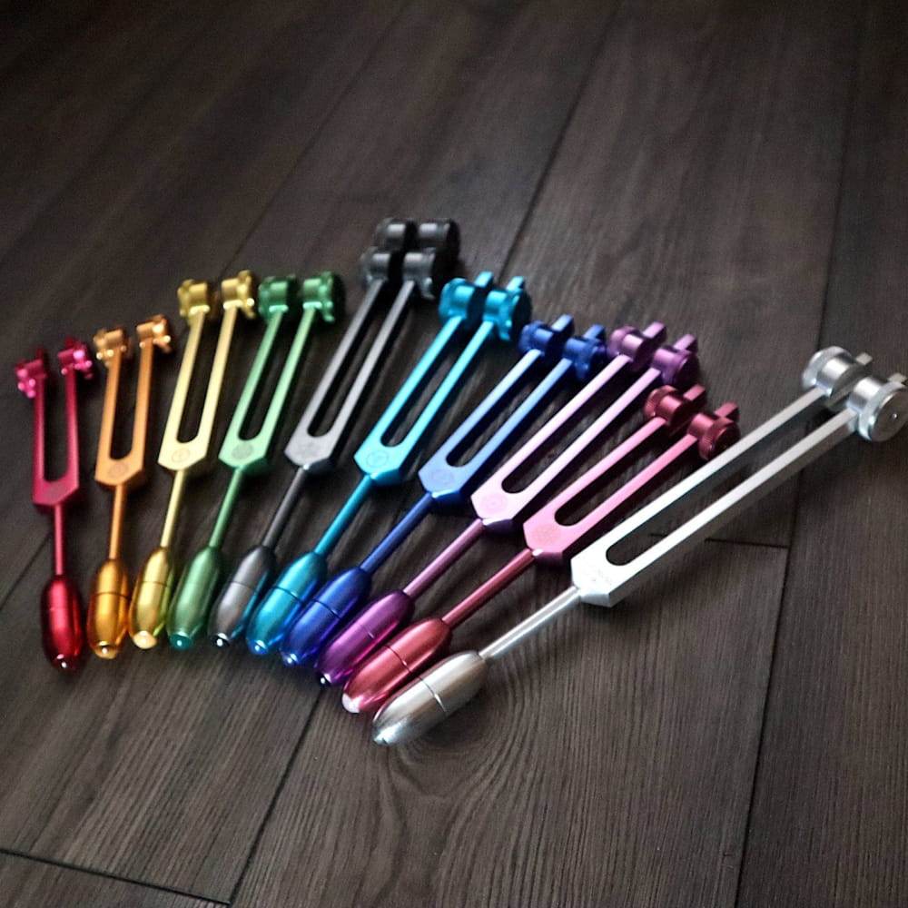 Colorful tuning forks in a rainbow spectrum for Chakra healing and crystal massage