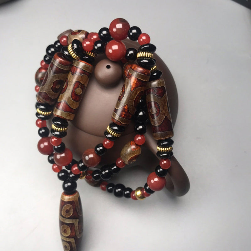 Collier de richesse en agate rouge à neuf yeux (9 x 12 mm)