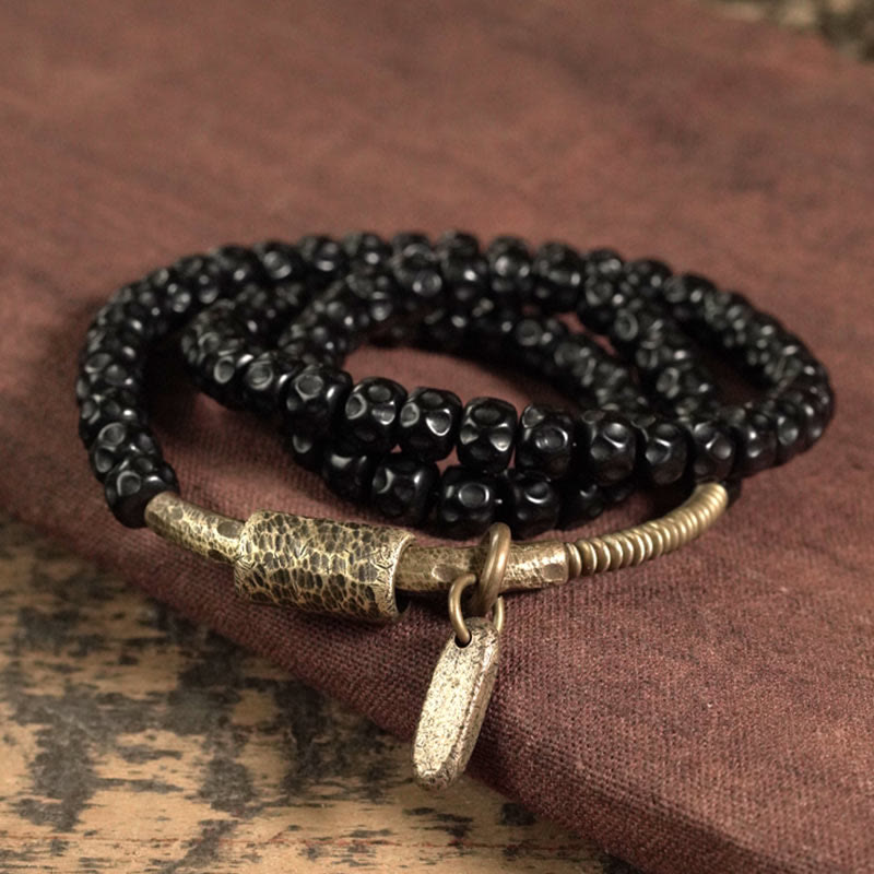 Bracelet spirituel triple tour en cuivre et coquille de noix de coco