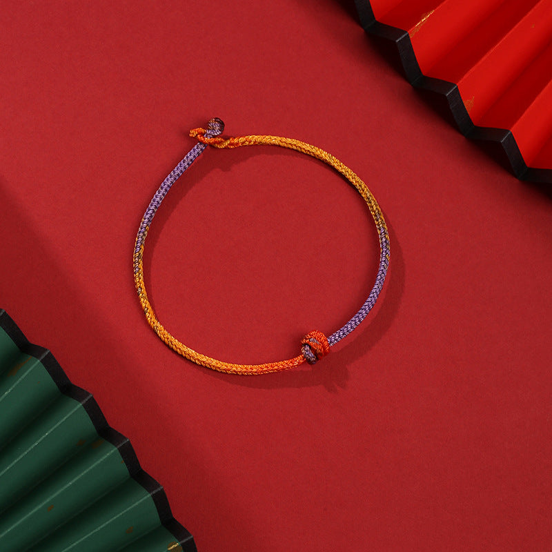 Bracelet en corde tressée colorée violette, dorée et rouge pour l'équilibre