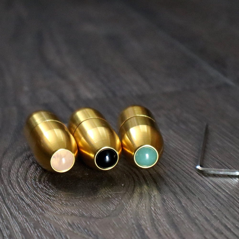 Three gold-plated bullet pendants with colorful gemstone tips for tuning forks