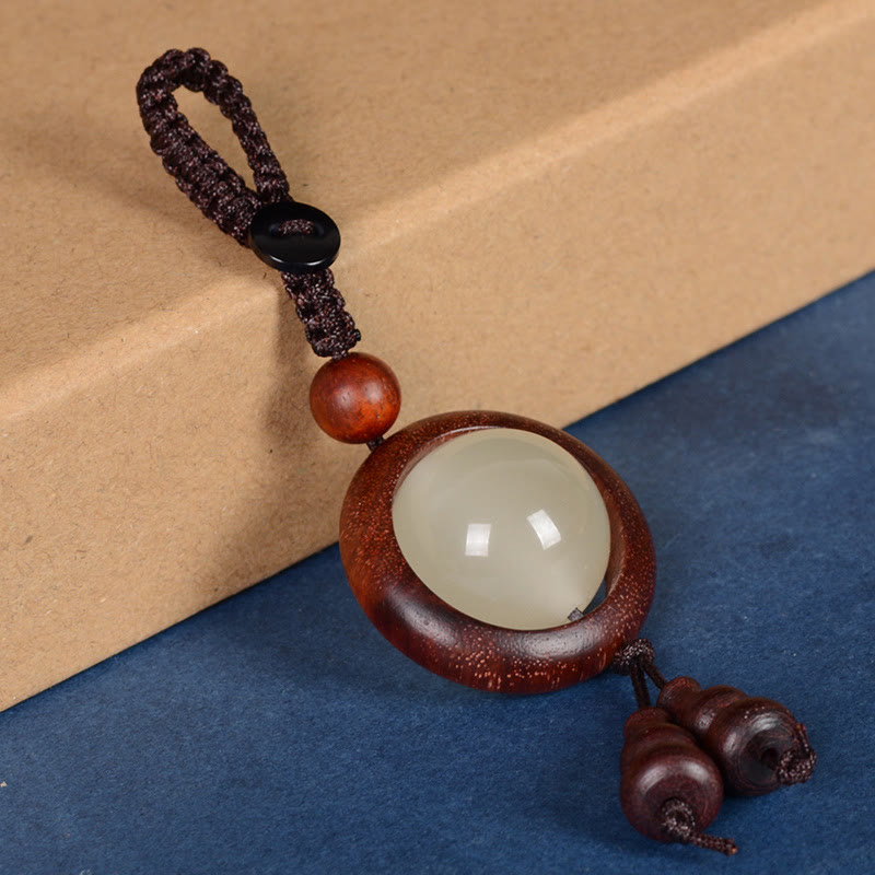 Porte-clés en bois d'ébène « Paix » | Perles lumineuses en bois de santal rouge et vert