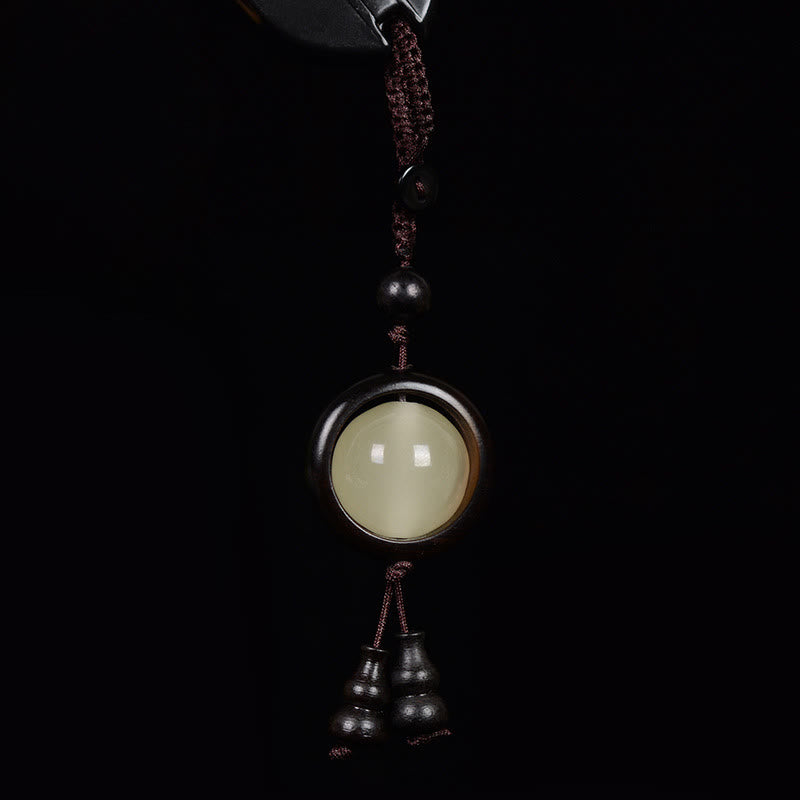 Porte-clés en bois d'ébène « Paix » | Perles lumineuses en bois de santal rouge et vert