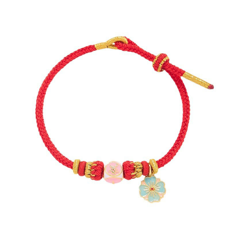 Bracelet de protection en cuivre plaqué or et fil rouge en forme de fleur de pêcher