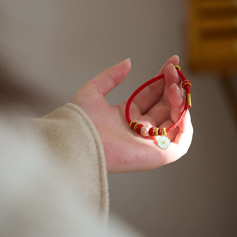 Bracelet de protection en cuivre plaqué or et fil rouge en forme de fleur de pêcher