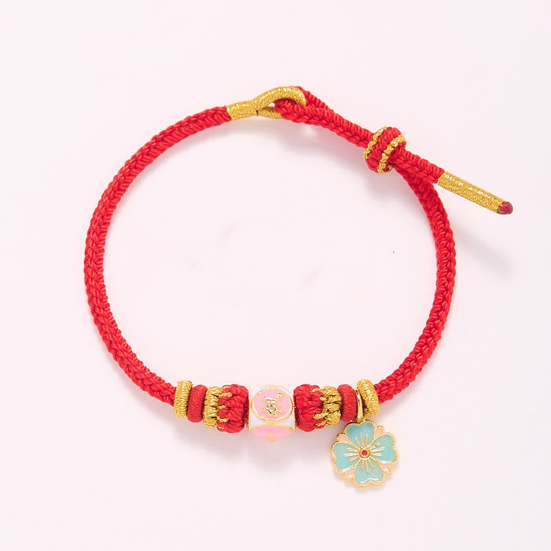 Bracelet de protection en cuivre plaqué or et fil rouge en forme de fleur de pêcher