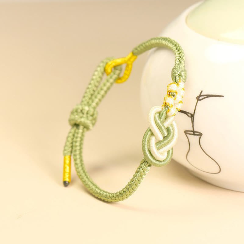 Bracelet artisanal à huit fils rouges avec nœud de paix