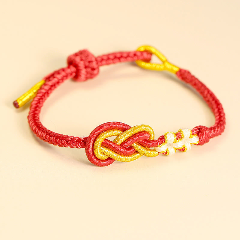 Bracelet artisanal à huit fils rouges avec nœud de paix