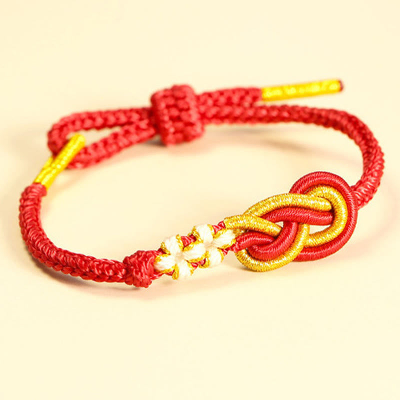 Bracelet artisanal à huit fils rouges avec nœud de paix