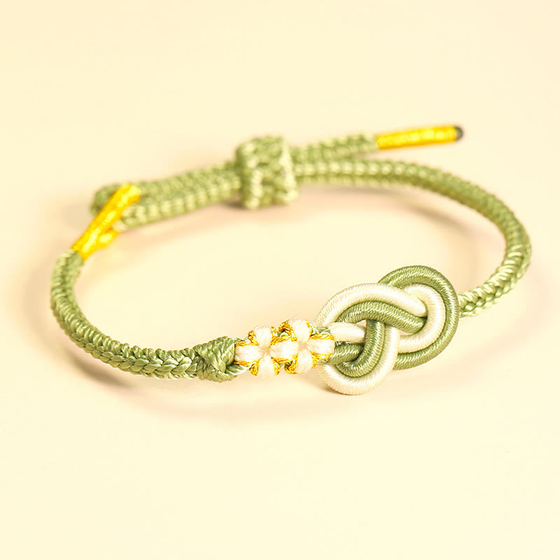 Bracelet artisanal à huit fils rouges avec nœud de paix