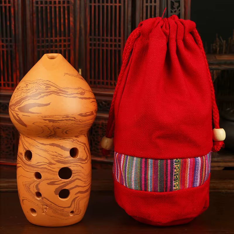 Decorative gourd-shaped ceramic vessel and red striped pouch with Handmade Ceramic Xun Flute
