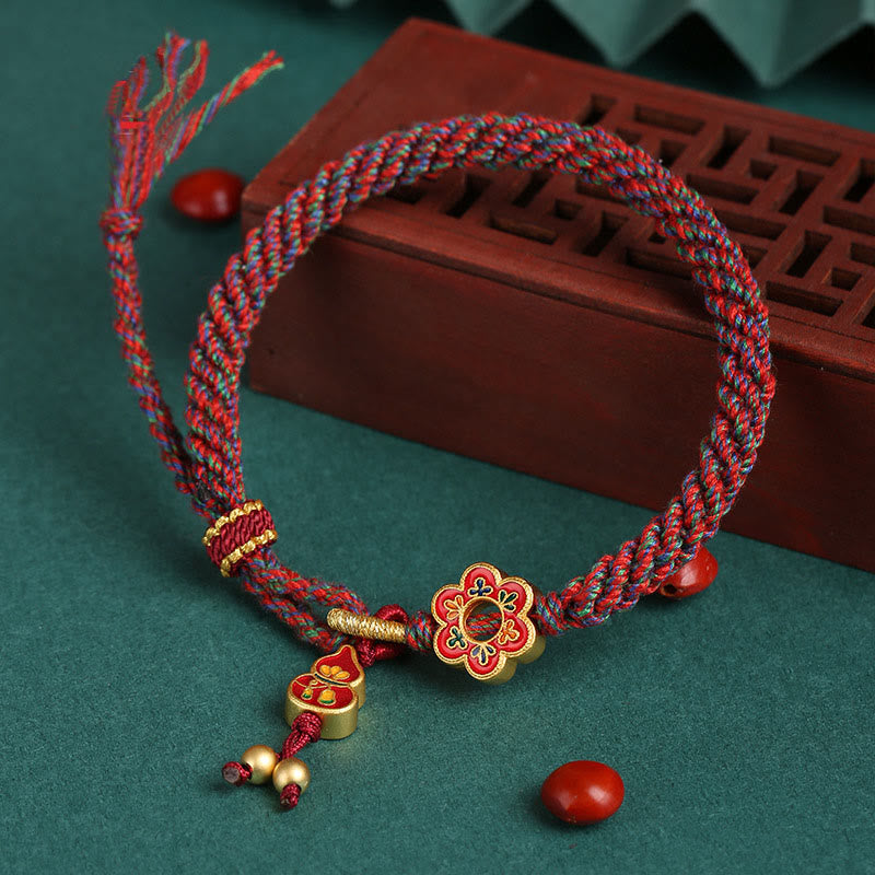 Bracelet de protection en fil rouge fait main avec fleur de courge colorée