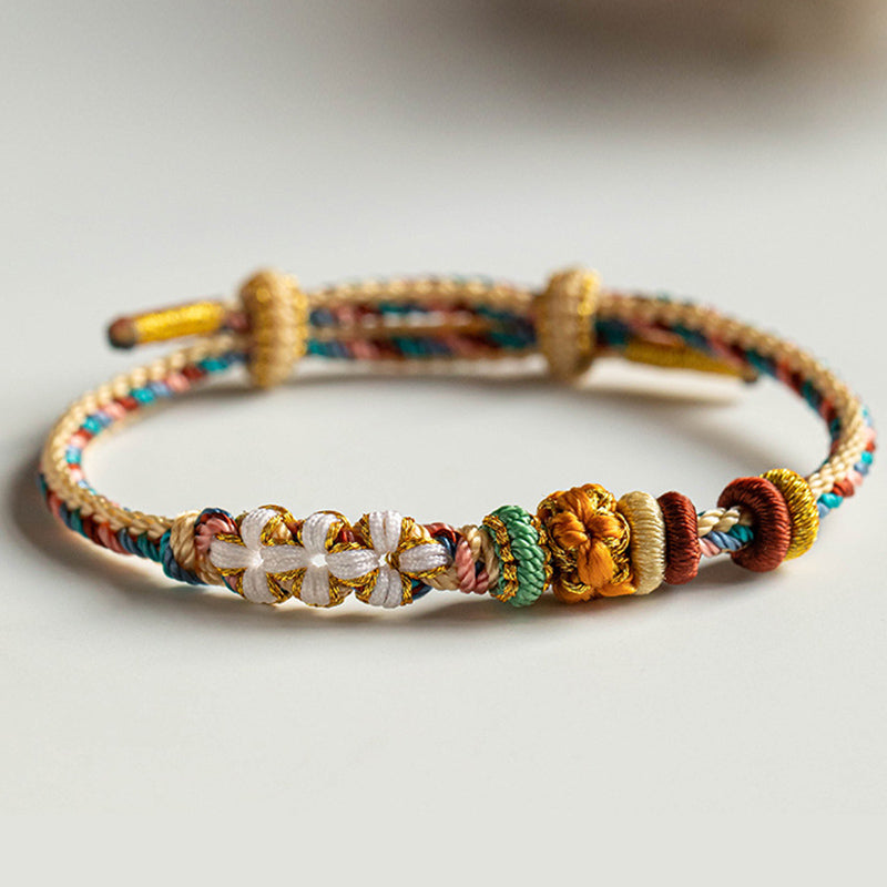 Bracelet en fil rouge à motif de fleurs de pêcher Dunhuang fait main