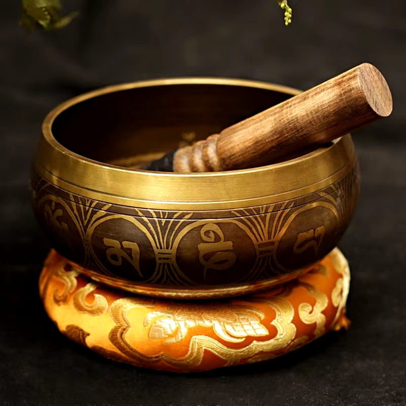 Handmade Tibetan Singing Bowl with ornate designs on decorative cushion for healing