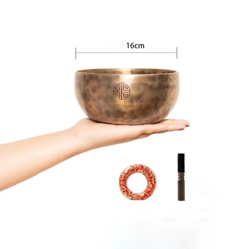 Bronze Tibetan singing bowl resting on a palm for meditation and yoga practice