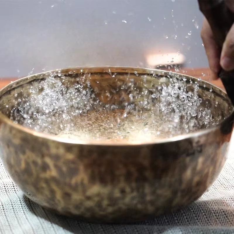 Metal bowl with bubbling liquid inside Handmade Tibetan Singing Bowl for Meditation Yoga