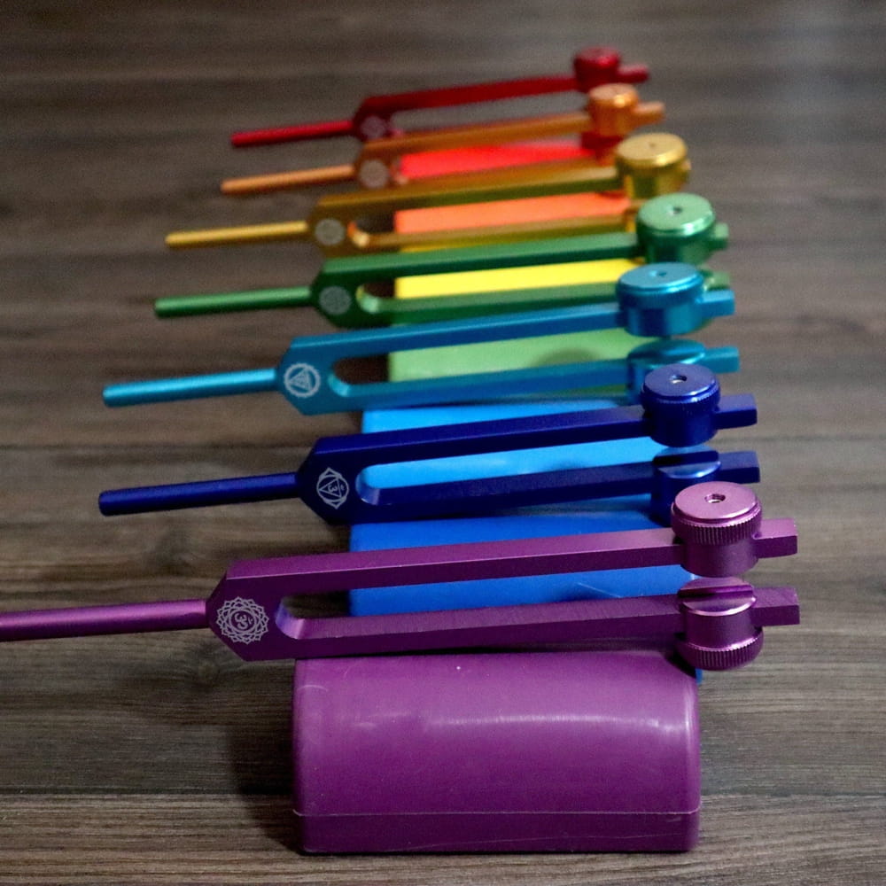 Rainbow-colored Healing Tuning Fork Activators arranged in a gradient pattern