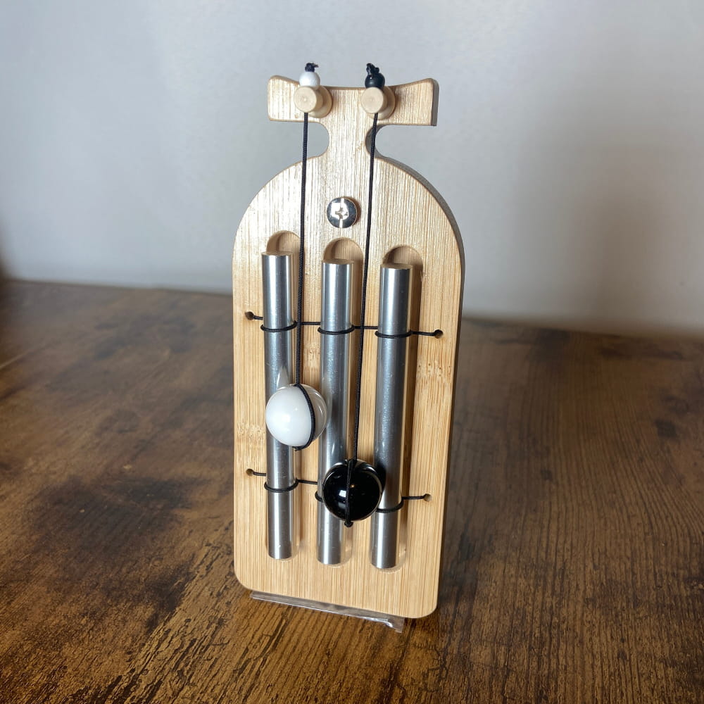 Wooden door chime with metal tubes and striking balls for cleansing and manifestation